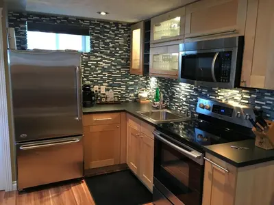 a kitchen with a stainless steel refrigerator and a sink at The White Brick Inn in Jasper