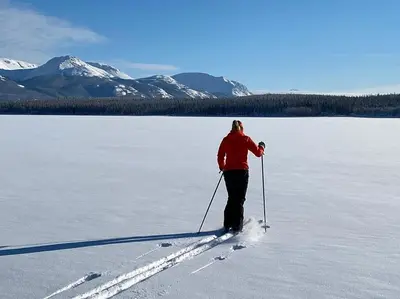 a person is cross country skiing on a frozen lake at Southern Lakes Resort in Tagish
