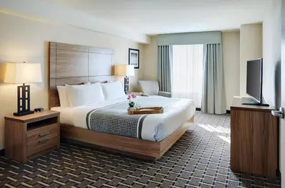 a hotel room with a large bed and a flat screen tv at Pomeroy Inn and Suites Vermilion in Vermilion