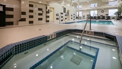 an indoor pool with a large swimming pool at Best Western PLUS Fort Saskatchewan Inn & Suites in Fort Saskatchewan