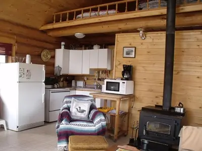 a kitchen with a stove and a chair in a room at Nimpo Lake Resort in Nimpo Lake