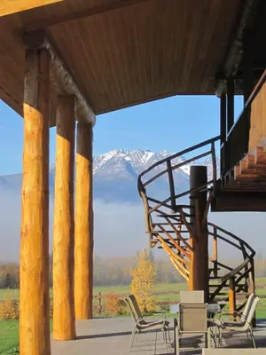 a porch with a view of a snow covered mountain at Smithers Driftwood Lodge in Smithers