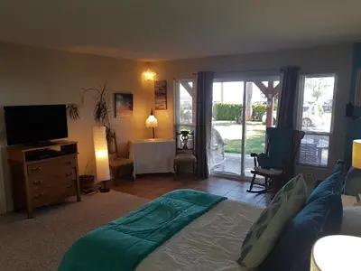 a bedroom with a bed and a television and a table at Davis Bay Bed & Breakfast in Sechelt