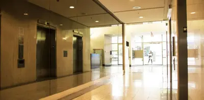 a hallway of a building with a person walking in the distance at Howe Street Apartment with Views in Vancouver