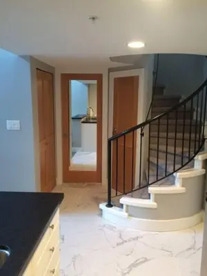 a room with a staircase and a stair case at Tyndalstone Lodge 3 Bedroom in the Heart of Village North Whistler in Whistler