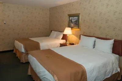 a hotel room with two beds and a lamp at Lakeview Inns & Suites - Fort Saskatchewan in Fort Saskatchewan