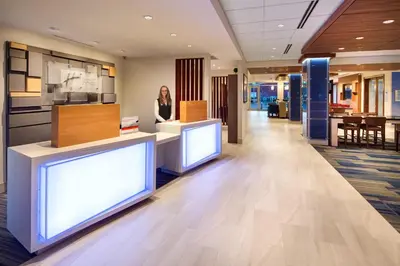 a woman is standing in the middle of an office lobby at Holiday Inn Express & Suites Terrace by IHG in Terrace