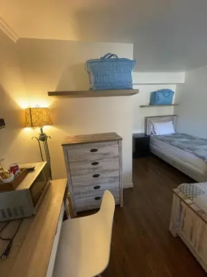 a small room with a desk and a bed at Sunset Motel in Cache Creek
