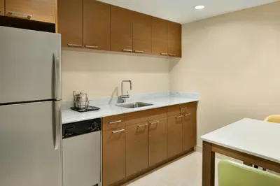 a kitchen with a refrigerator and a sink at The Westin Wall Centre, Vancouver Airport in Richmond