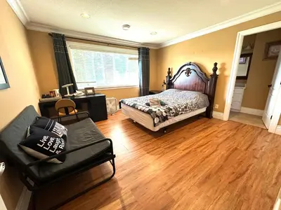 a bedroom with a bed and a couch at Vancouver Luxury Homestay in Richmond