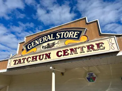 a sign for a central store cafeteria centre on a building at Hotel Carmacks in Carmacks