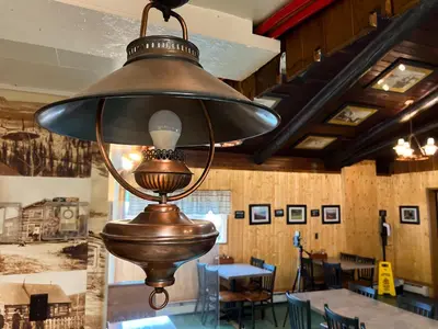 a large lamp hanging from the ceiling in a restaurant at Hotel Carmacks in Carmacks
