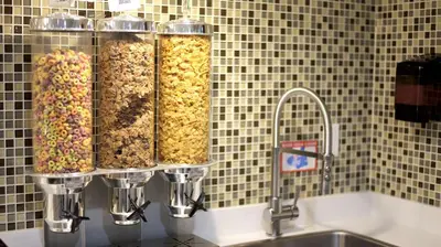 four containers of nuts on a counter next to a sink at Best Western Peace Arch Inn in Surrey