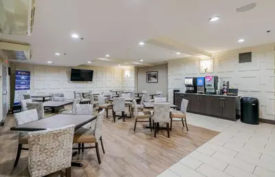 a dining room with tables and chairs in a restaurant at Best Western Peace Arch Inn in Surrey