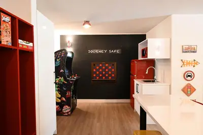 a kitchen with a black wall and a red refrigerator at Super 8 by Wyndham Calgary Shawnessy Area in Calgary