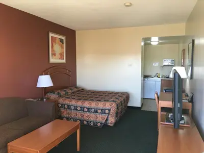 a hotel room with a bed and a couch at Western Valley Inn in Valleyview