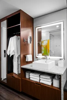 a bathroom with a sink and a mirror at Hotel Arts in Calgary