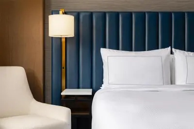 a bed and a chair in a hotel room at Doubletree By Hilton West Kelowna in West Kelowna