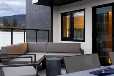 a patio with a couch and a table and chairs at Doubletree By Hilton West Kelowna in West Kelowna