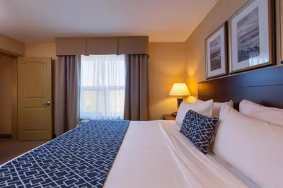 a hotel room with a bed and a window at Bayview Hotel in Courtenay