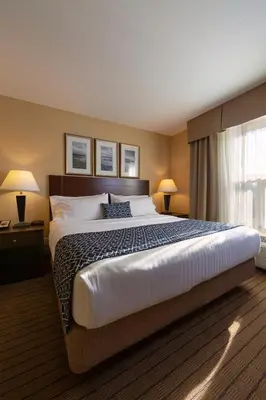 a hotel room with a large bed and a window at Bayview Hotel in Courtenay