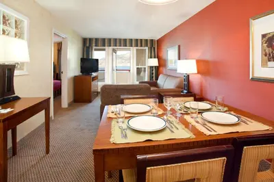 a dining room with a table and a living room at Holiday Inn Hotel & Suites Osoyoos by IHG in Osoyoos