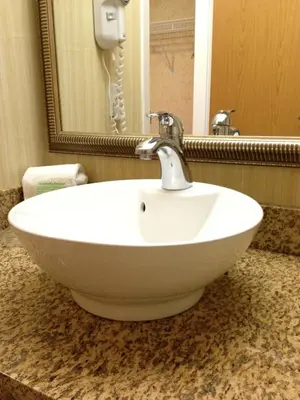 a white sink in a bathroom with a mirror at Holiday Inn Hotel & Suites Osoyoos by IHG in Osoyoos