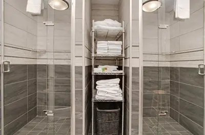 a bathroom with a shower and a walk in shower at Guest House Inn & Suites in Edson