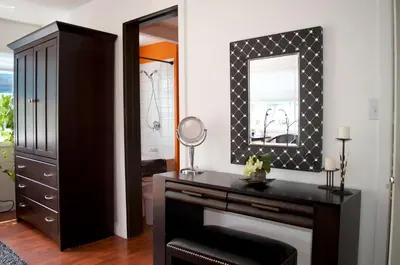 a bedroom with a dresser and a mirror at A Float Home B&B in Fisherman’s Wharf in Victoria