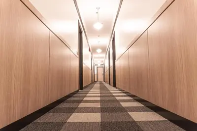 an empty corridor with wooden walls and a checkered floor at Swans Brewery, Pub & Hotel in Victoria