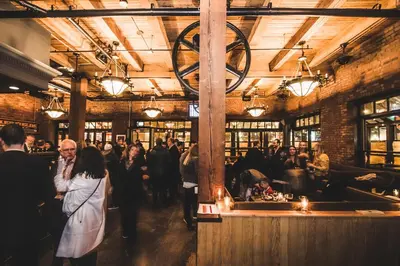 a crowd of people walking around a bar in a building at Swans Brewery, Pub & Hotel in Victoria