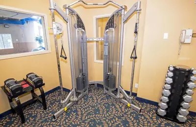a gym with a bunch of gym equipment in a room at Holiday Inn Express Hotel & Suites Edson by IHG in Edson