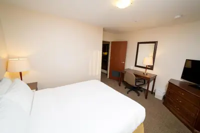 a hotel room with a bed and a desk and a television at Holiday Inn Express & Suites Drayton Valley by IHG in Drayton Valley