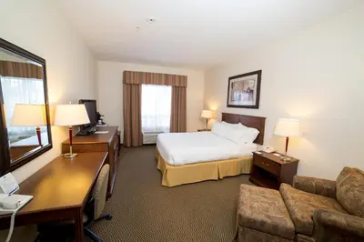 a hotel room with a bed and a couch at Holiday Inn Express & Suites Drayton Valley by IHG in Drayton Valley