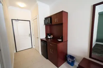 a room with a cabinet with a microwave and a door at Nova Inn Manning in Manning