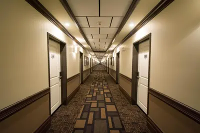 a hallway in an office building with a long corridor at Nova Inn Manning in Manning