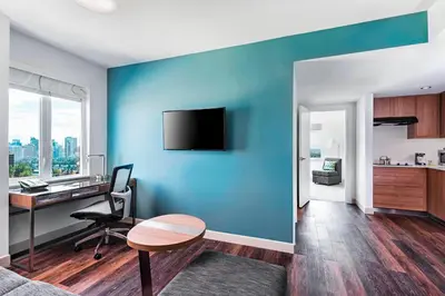 an office with a blue wall with a desk at Element Calgary Airport in Calgary