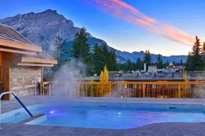 a swimming pool with a mountain in the background at Moose Hotel and Suites in Banff
