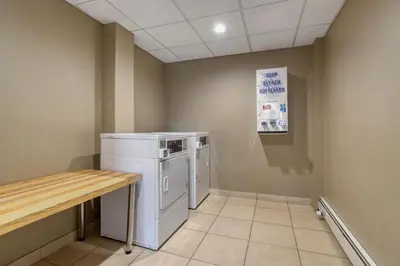 a laundry room with a washer and dryer at Best Western PLUS Fox Creek in Fox Creek