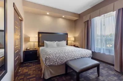 a hotel room with a bed and a window at Best Western PLUS Fox Creek in Fox Creek
