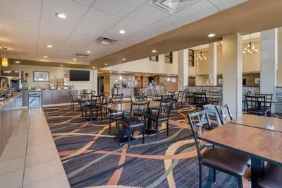 a large dining room with tables and chairs at Best Western PLUS Fox Creek in Fox Creek