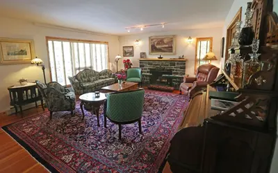a living room filled with furniture and a fireplace at Beaujolais Boutique B&B at Thea's House- Adults Only in Banff