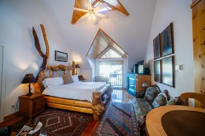 a bedroom with a large bed and a couch at Beaujolais Boutique B&B at Thea's House- Adults Only in Banff