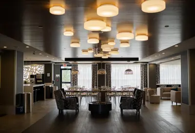 a dining room with a table and chairs and lights at Best Western Plus Airdrie Gateway in Airdrie