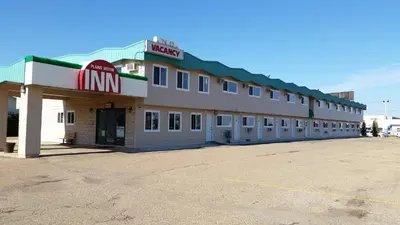 a mcdonalds building with a sign on the side of it at Plains Motor Inn in Stettler