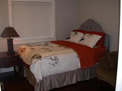 a bedroom with a bed and a window at Vancouver Austin Guesthouse in Coquitlam