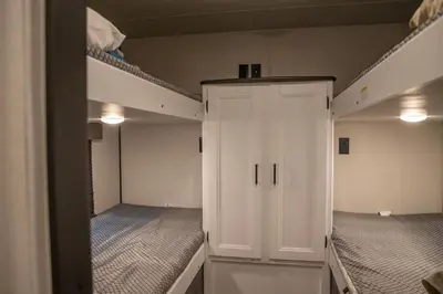 a room with two bunk beds and a white closet at Jasper Gates Resort in Jasper