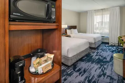 a hotel room with a bed and a tv at Fairfield Inn & Suites by Marriott Edmonton North in Edmonton