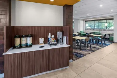 a lobby with a bar with bottles of wine at Fairfield Inn & Suites by Marriott Edmonton North in Edmonton