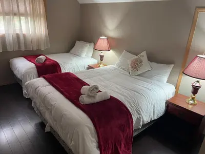 a bedroom with two beds with towels on them at Blaeberry Valley Vacation Rentals in Golden